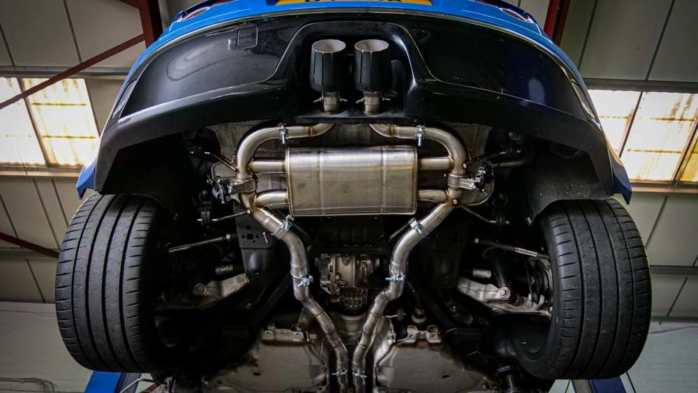 Photo of car with new exhaust - car raised in the air showing the underneath. Featured image for our article on 'what is an aftermarket exhaust'